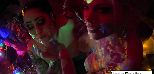  Black-light babes Nadia White and Ophelia suck off a colorful cock